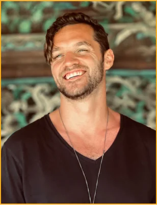 Man with a necklace smiling